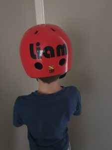 Custom vinyl die cut sticker showing a name on a child's bike helmet