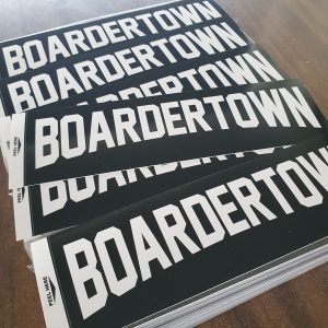 Stack of screenprinted bumper stickers for boardertown